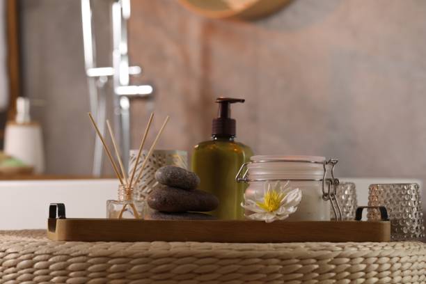 istock Different spa products and beautiful flower on wicker table in bathroom 1955689080
