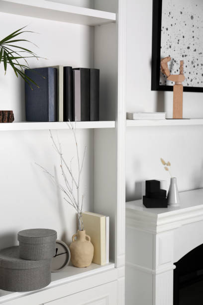 istock White shelves and fireplace with different decor indoors. Interior design 1955690169