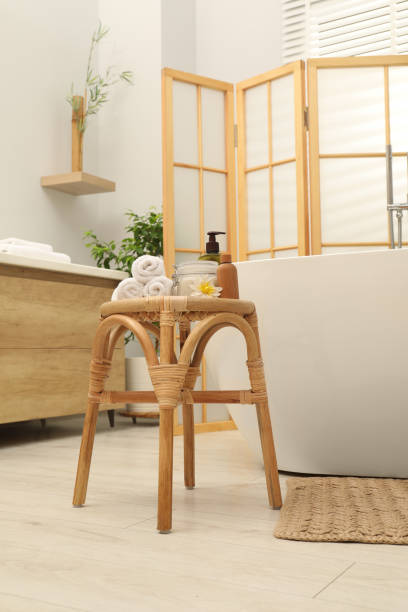 istock Different spa products on wicker table near ceramic tub in bathroom 1955693325