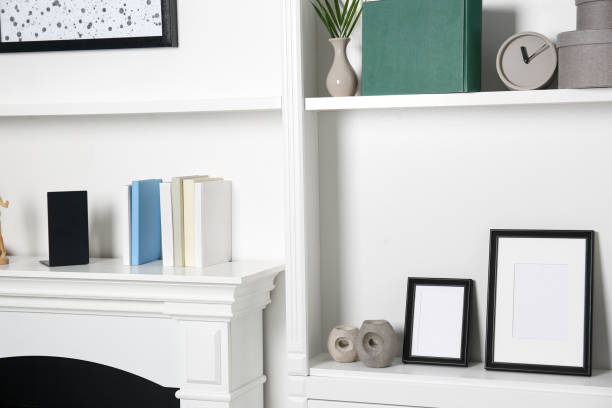 istock White shelves and fireplace with different decor indoors. Interior design 1955693334