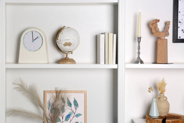 istock White shelves with books, globe and different decor indoors. Interior design 1955702670