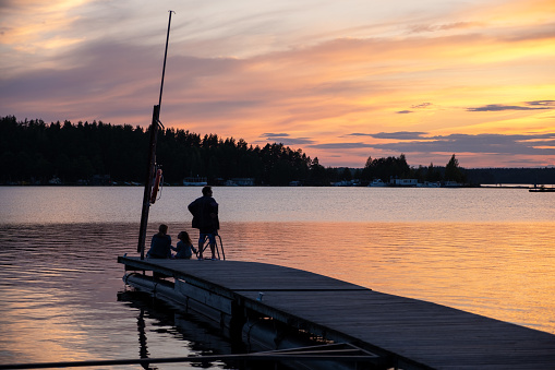 A family relaxes on a summer evening on a lake not far from Imatra, Finland