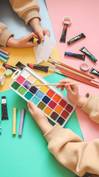 istock Back to school. Panoramic education banner. Top view, flat lay. Colorful supplies on table, colored paper. Children's creativity concept. Preschool study, development. Accessories for the schoolroom 1955721359