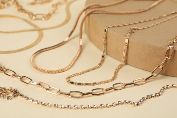 istock Different metal chains on beige background, closeup. Luxury jewelry 1955731894