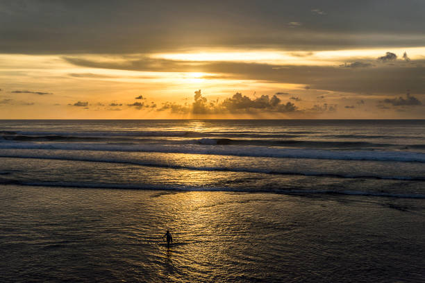 istock Balinese Bliss: Sunset Surfing on the Golden Waters 1955749371