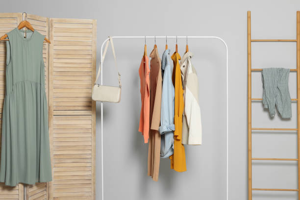 istock Stylish room interior with clothes rack and folding screen 1955755702