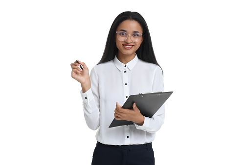 Beautiful secretary with clipboard and pen on white background