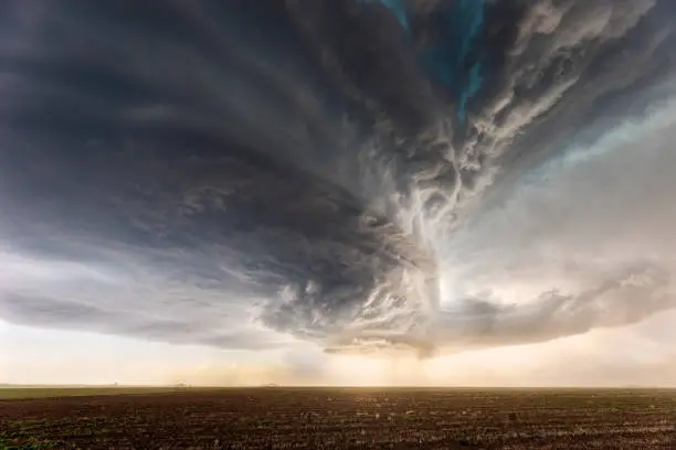 Dramatic sky with ominous supercell storm clouds over a field in Texas. Extreme weather or severe thunderstorm concept.