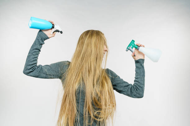 istock Female messy long hair holds spray bottle 1955799656