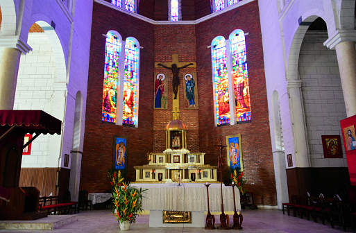 Cameroon, Douala: Cathedral of St Peter and St Paul of Bonadibong, built by French Spiritan friars - altar, crucifix and stained glass windows - Roman Catholic Archdiocese of Douala - (cathedrale St Pierre et St Paul)