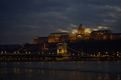 view of the chain bridge in Budapest in the evening, yellow illumination