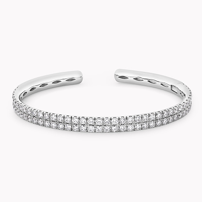 This exquisite white gold diamond cuff bracelet boasts timeless elegance, adding a touch of sophistication to any ensemble.