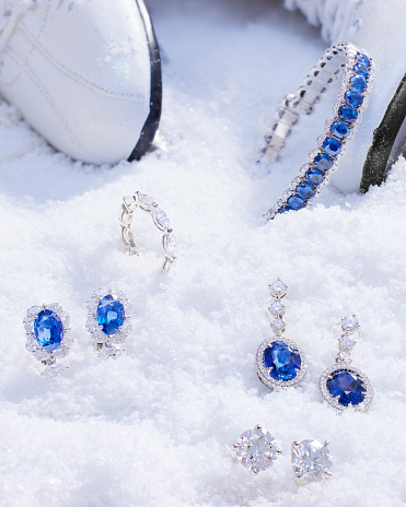 In this mesmerizing photo, a dazzling assortment of jewelry creates a striking contrast against a pure white bed of snow.