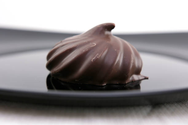 delicious dessert Marshmallows in chocolate on a black plate female hand takes lunch homemade handmade beautiful restaurant serving Reflection close-up advertising confectioner courses life is good