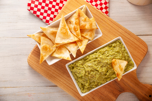 Guacamole. Avocado dip sauce, one of its many ways of consuming it is spread on tortilla chips also called Nachos. Mexican easy homemade sauce recipe very popular.