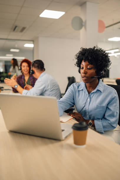 istock African american female agent wearing headset and resolving problems remotely 1955876584