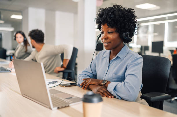 istock African american woman working on a computer in a call center. 1955876588