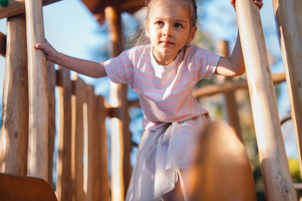 istock A Happy Adorable Girl Looking Away While Playing On The Playground 1955925205