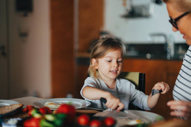 istock A Happy Beautiful Cute Girl Having Breakfast At Home 1955925729