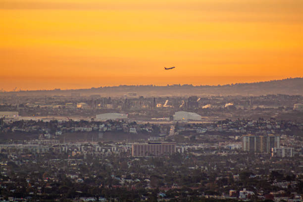 istock Plane takeoff at sunrise over urban city 1956001715