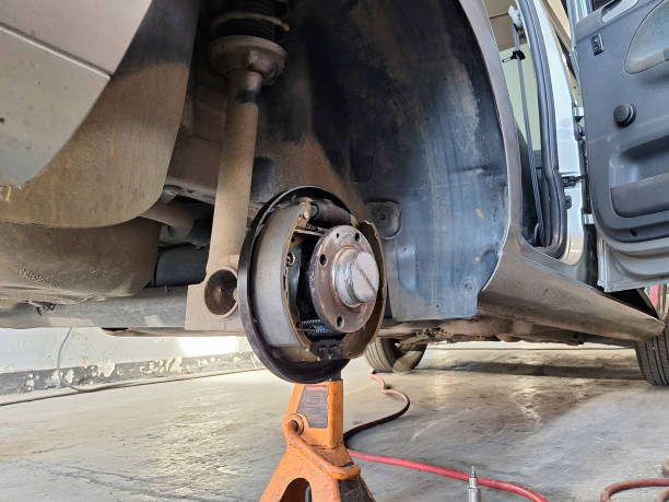 istock a car without the rear wheel in an automotive workshop 1956066412