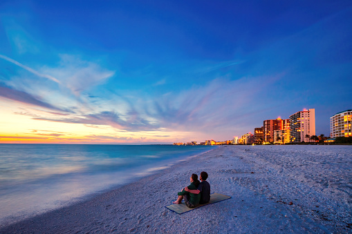 Couple Enjoys Beach Sunset in Marco Island, Naples, Florida, USA.