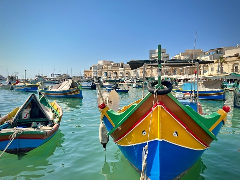 view of a traditional colorful wooden boat from mate island in marsaxlokk port on a sunny summer day