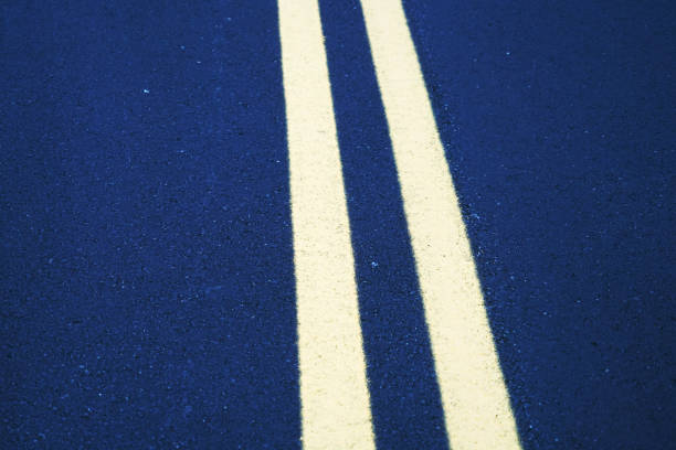 double yellow lines on new paved asphalt road surface