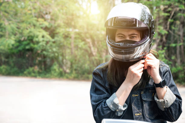 istock Confidence Asian woman wearing a motorcycle helmet before riding. 1956130721