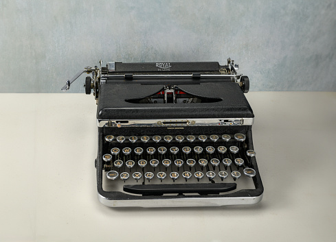 white typewriter with silver keys