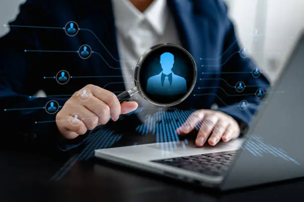 Human Resources Manager using magnifier glass finding with human icons, HRM, CRM, Recruitment Consultants, Headhunter, recruitment agency, Human Resources Management Concepts.