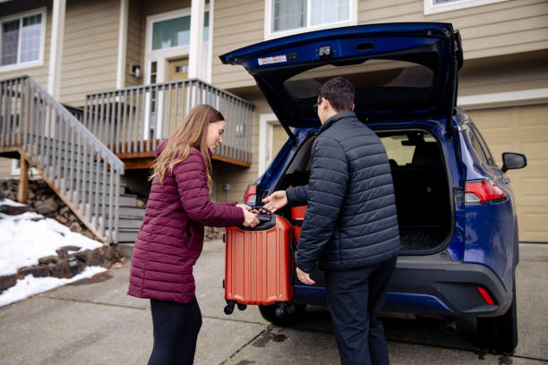 istock Young couple loading suitcases into car trunk, ready for an adventure 1956169271