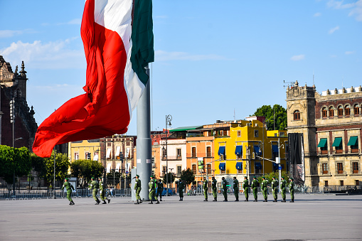 Mexico City, Mexico ; April 26 2020: flag ceremony in the mexico city zócalo square, lowering of the flag, backgroung Cathedral