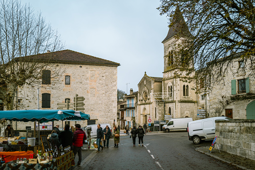December 23, 2023, Montcuq, France:Locals and tourists  buying local cheese at the weekend market. Street markets in Montcuq are held every weekend. Local people and tourists come along to buy local produce on the bustling stalls.Montcuq  is a town and former commune in the Lot department in south-western France near Cahors.