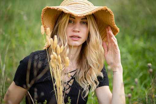 portrait of a girl in a straw hat. Natural beauty and lightness, boho style in a summer look.