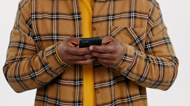 Phone, hands or man in studio on social media to scroll for internet post or website notification. Communication closeup, white background or person texting a message on online networking mobile app