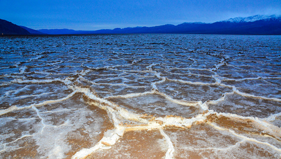 Death Valley National Park, Salt with clay, California. Smooth salt valley with cracked and swollen salt, dead salt landscape