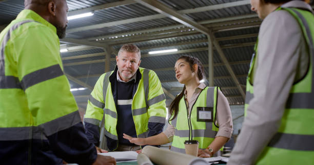 istock Engineer, team and tablet in meeting, planning or collaboration for construction on site. Architect group in discussion with technology for architecture, floor plan or building layout at workshop 1956228234