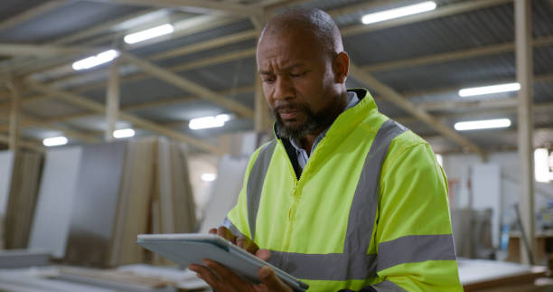 istock Black man, architect and tablet in construction for research, social media or communication on site. African male person, contractor or engineer with technology for online search or architecture 1956228241