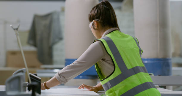 istock Woman, safety and construction on site, architect and back for building samples, wood and design. Professional, female person and industrial blueprint for engineering project and contractor 1956228749