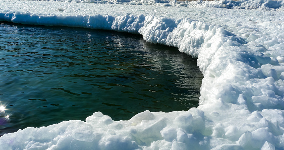 Frozen Black Sea, blocks of melting ice on the seashore