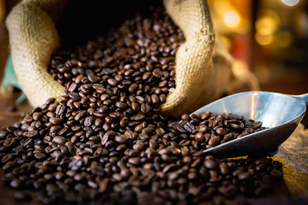 istock Cup of coffee, bag and scoop on old wooden background, with copy space. 1956242532
