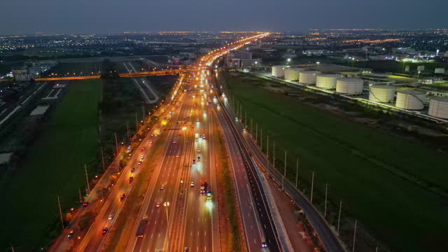 Aerial View of Highway Interchange near oil refinery plant during morning.