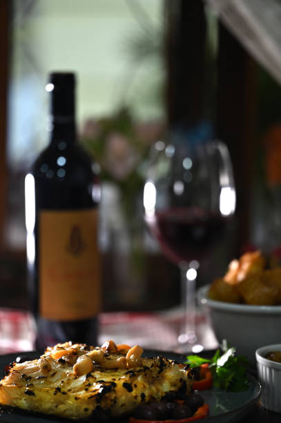 roast cod with salad wine and olive oil Portuguese fish bacalhoada typical Portuguese food taste