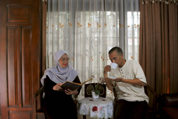 istock Happy couple enjoying afternoon tea. 1956315045
