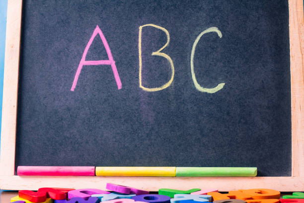 istock English letters scattered on a black background 1956315046