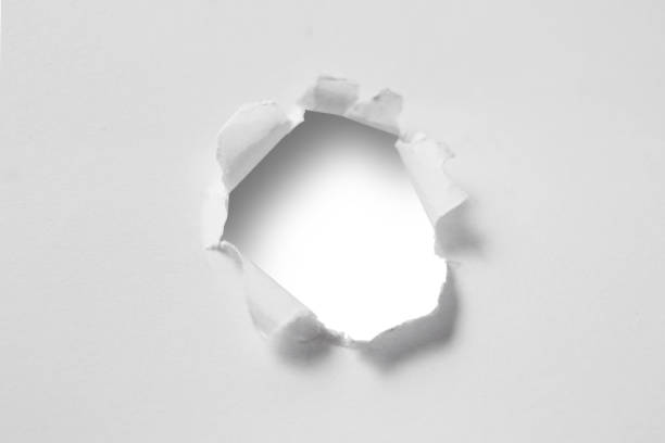 istock Ragged hole on ripped paper, cut out isolated 1956336852
