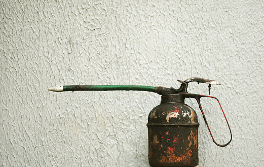An oil can is a can that holds oil, usually motor oil, for lubricating machines and oil-based lanterns. Oil cans have a spout designed to release oil drop by drop.