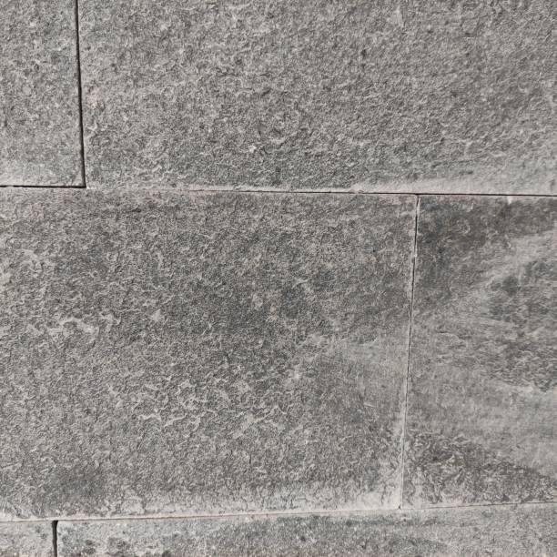 istock gray natural stone wall background 1956391543