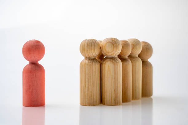 istock Closeup view crowd of wooden figures 1956401392